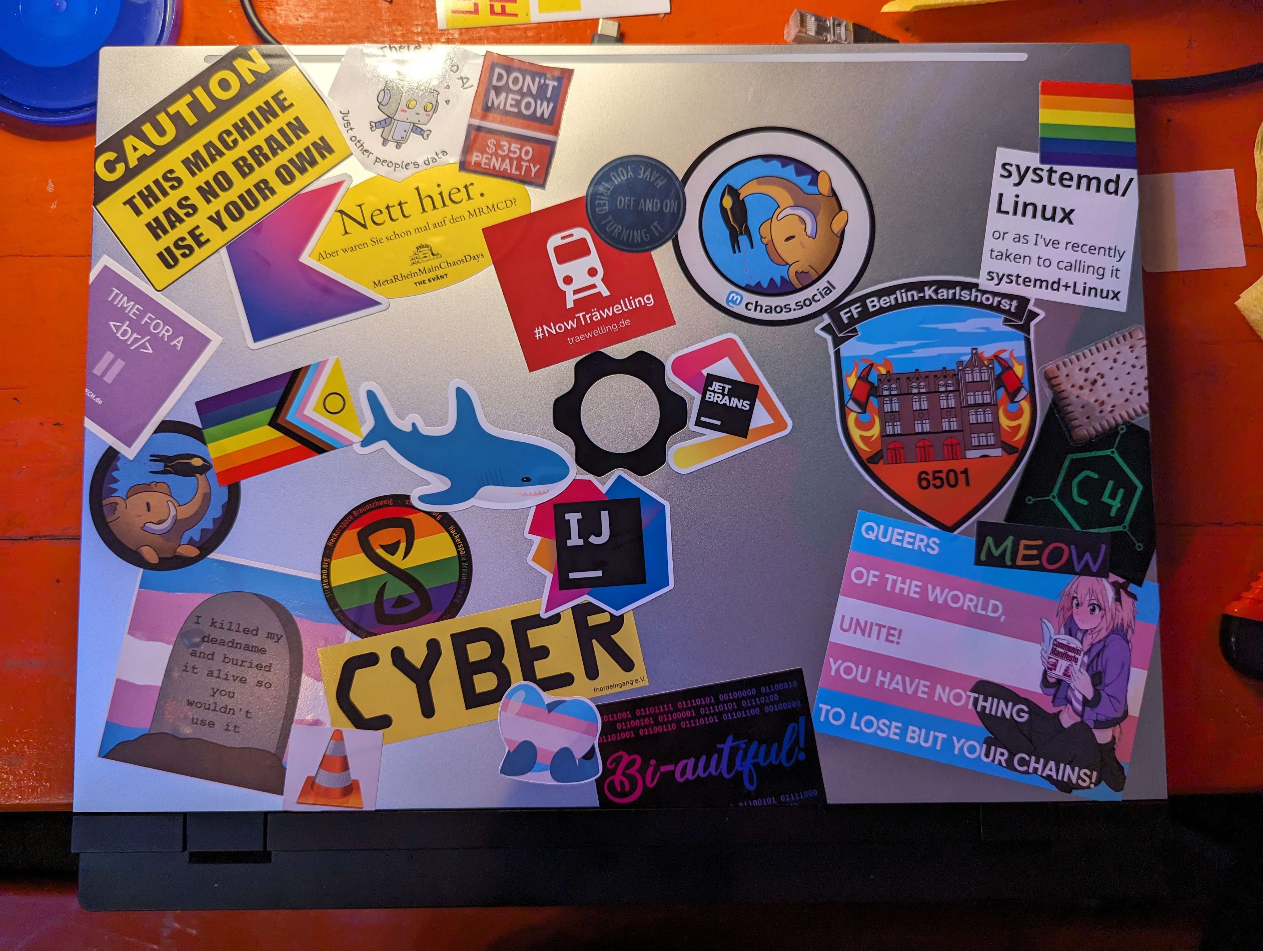 A picture of a laptop with a lots of stickers